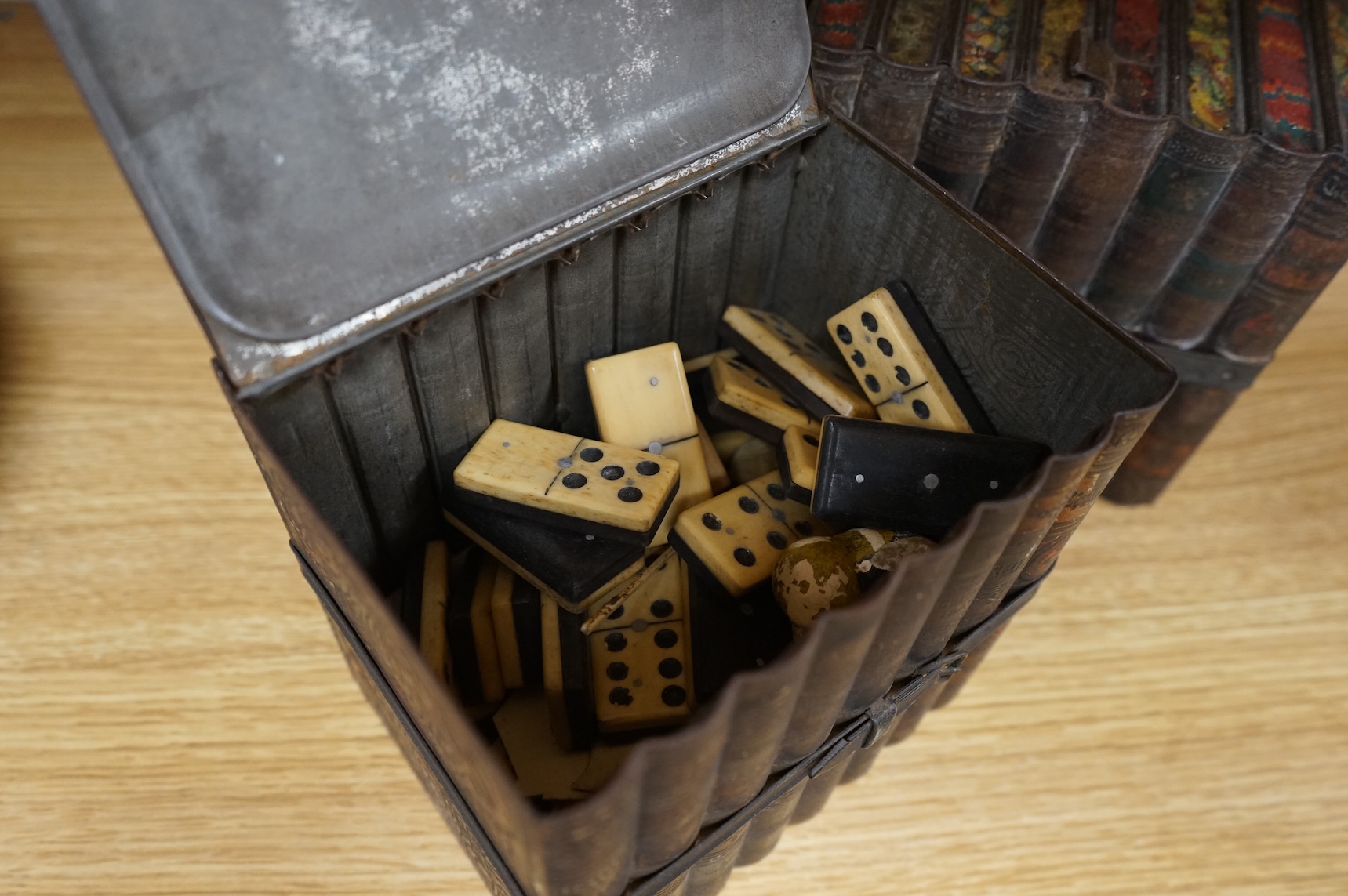 Two Huntley and Palmers novelty biscuit tins, each modelled as a set of books, 16cm